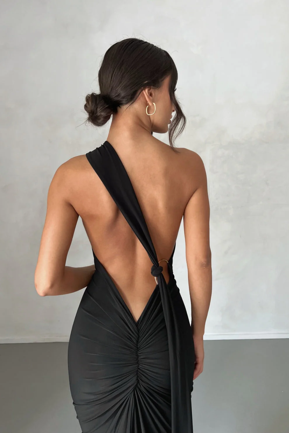 Abby backless maxi dress featuring a one-shoulder neckline, floor-length silhouette, subtle side slit and fluid drape. Stretch fabric molds to the body with a soft lining for coverage. Cotton, polyester, elastane blend—ideal for formal events.