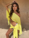 Two-piece linen sarong set featuring a draped, off-shoulder crop top and a wrap mini skirt tied at the hip. Breathable, lightweight fabric and an airy silhouette create a relaxed yet polished look for beach, resort and warm-weather outings.