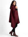 Alannah dark brown knit poncho cape featuring a refined high neckline and fluid, side-draped silhouette. Soft, medium-weight knit provides cozy warmth and effortless layering over jeans, tailored trousers or dresses for elevated everyday looks.