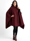 Alannah dark brown knit poncho cape featuring a refined high neckline and fluid, side-draped silhouette. Soft, medium-weight knit provides cozy warmth and effortless layering over jeans, tailored trousers or dresses for elevated everyday looks.