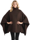 Alannah dark brown knit poncho cape featuring a refined high neckline and fluid, side-draped silhouette. Soft, medium-weight knit provides cozy warmth and effortless layering over jeans, tailored trousers or dresses for elevated everyday looks.