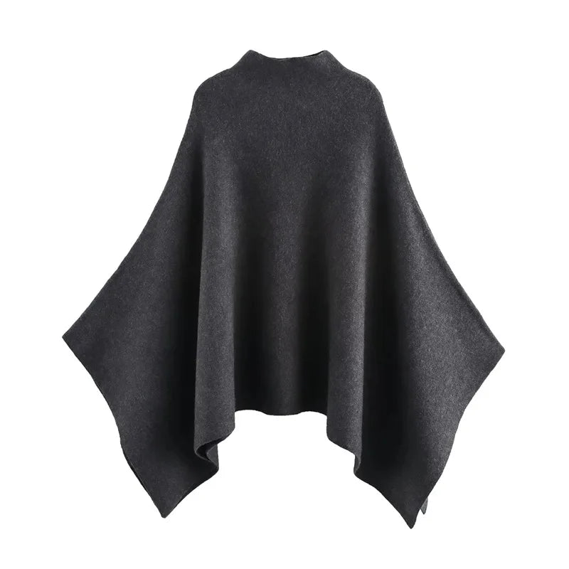 Alannah dark brown knit poncho cape featuring a refined high neckline and fluid, side-draped silhouette. Soft, medium-weight knit provides cozy warmth and effortless layering over jeans, tailored trousers or dresses for elevated everyday looks.