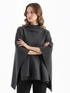 Alannah dark brown knit poncho cape featuring a refined high neckline and fluid, side-draped silhouette. Soft, medium-weight knit provides cozy warmth and effortless layering over jeans, tailored trousers or dresses for elevated everyday looks.