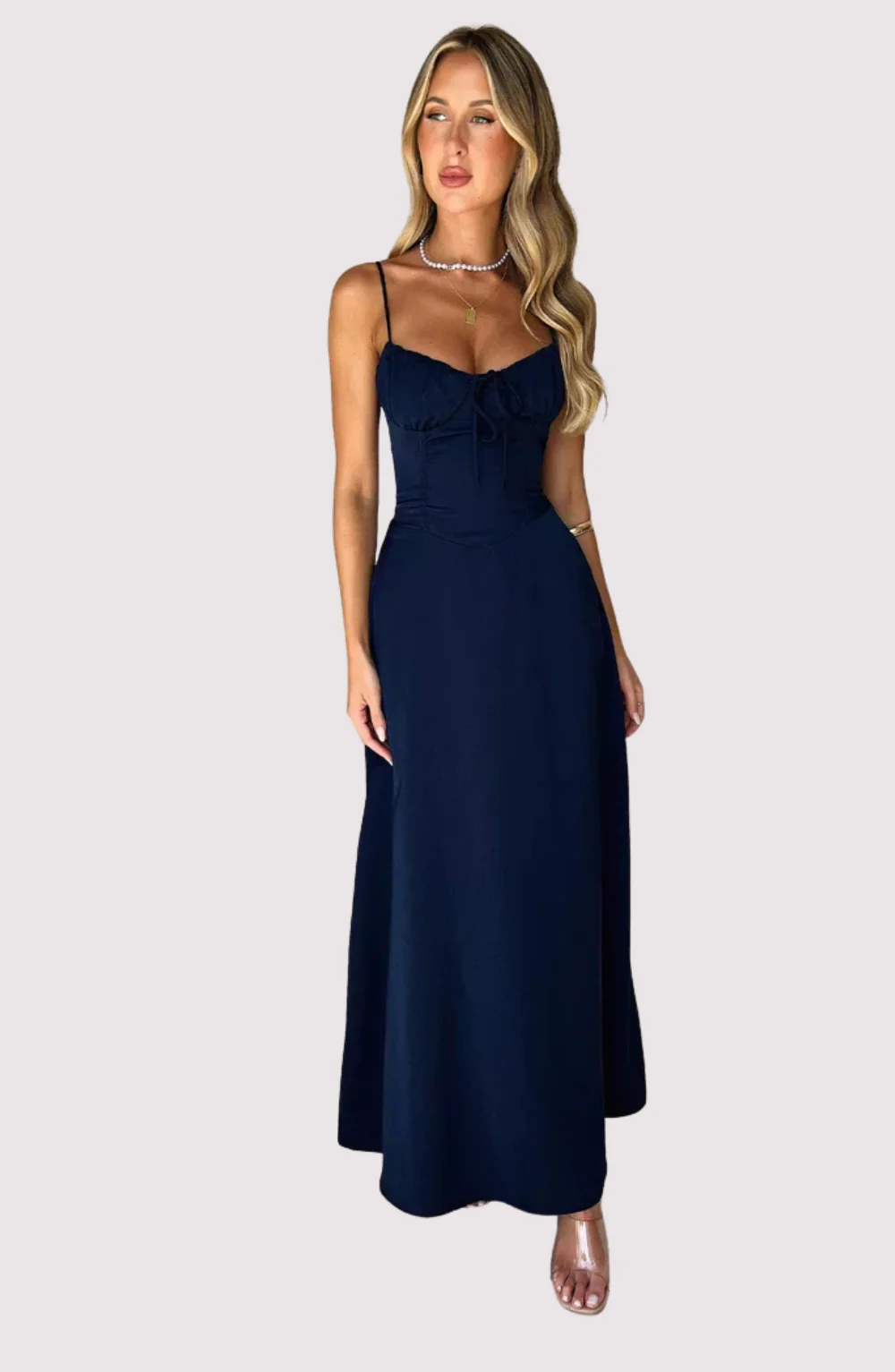 Maxi dress with delicate straps, ruched bust and lace-up back for a custom fit, finished with a flowing A-line skirt. Lightweight, breathable fabric offers graceful movement for weddings, soirées, parties or elegant daytime wear.