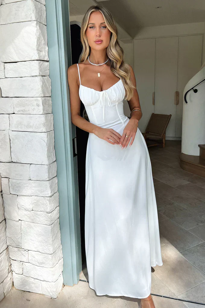Maxi dress with delicate straps, ruched bust and lace-up back for a custom fit, finished with a flowing A-line skirt. Lightweight, breathable fabric offers graceful movement for weddings, soirées, parties or elegant daytime wear.