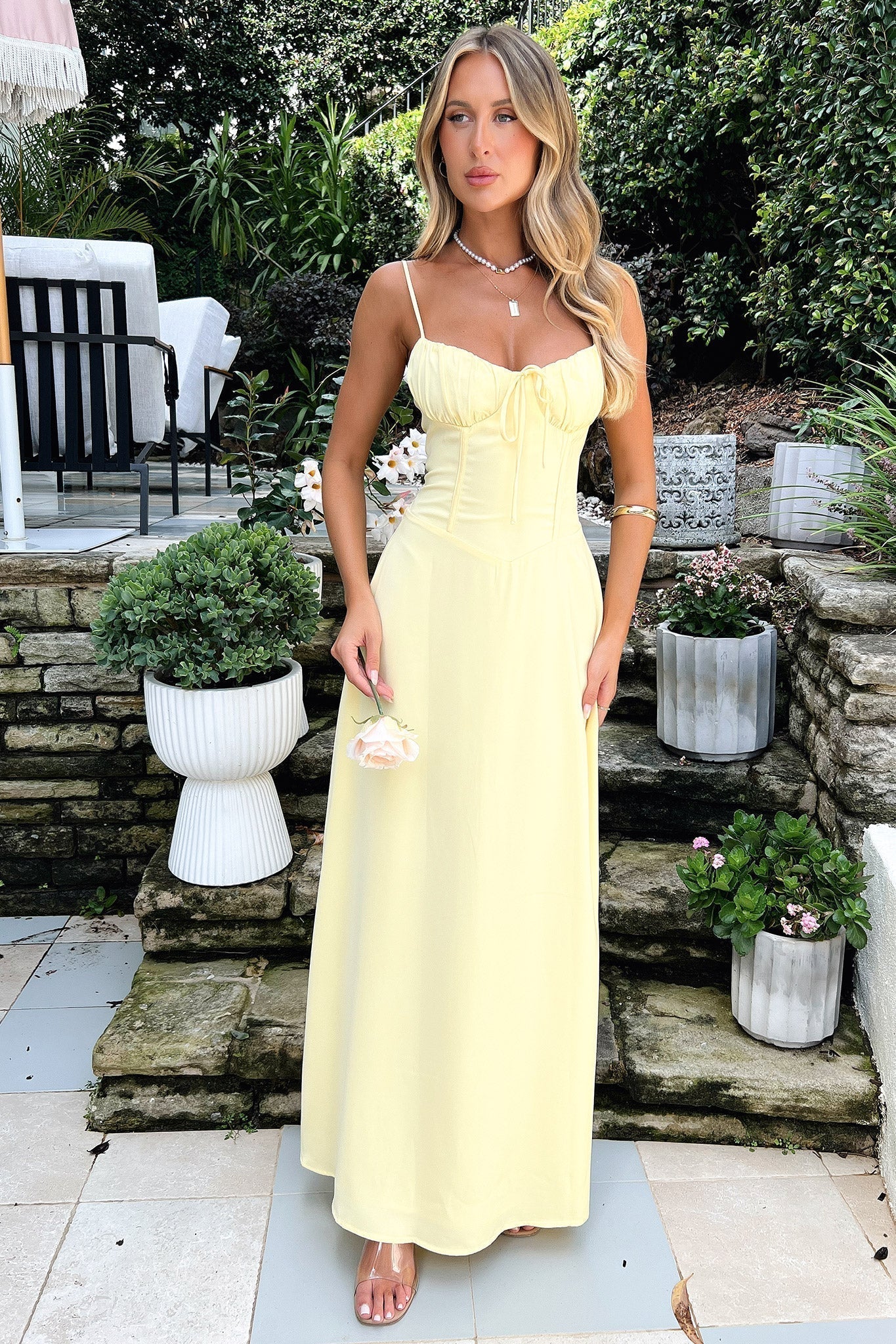 Maxi dress with delicate straps, ruched bust and lace-up back for a custom fit, finished with a flowing A-line skirt. Lightweight, breathable fabric offers graceful movement for weddings, soirées, parties or elegant daytime wear.