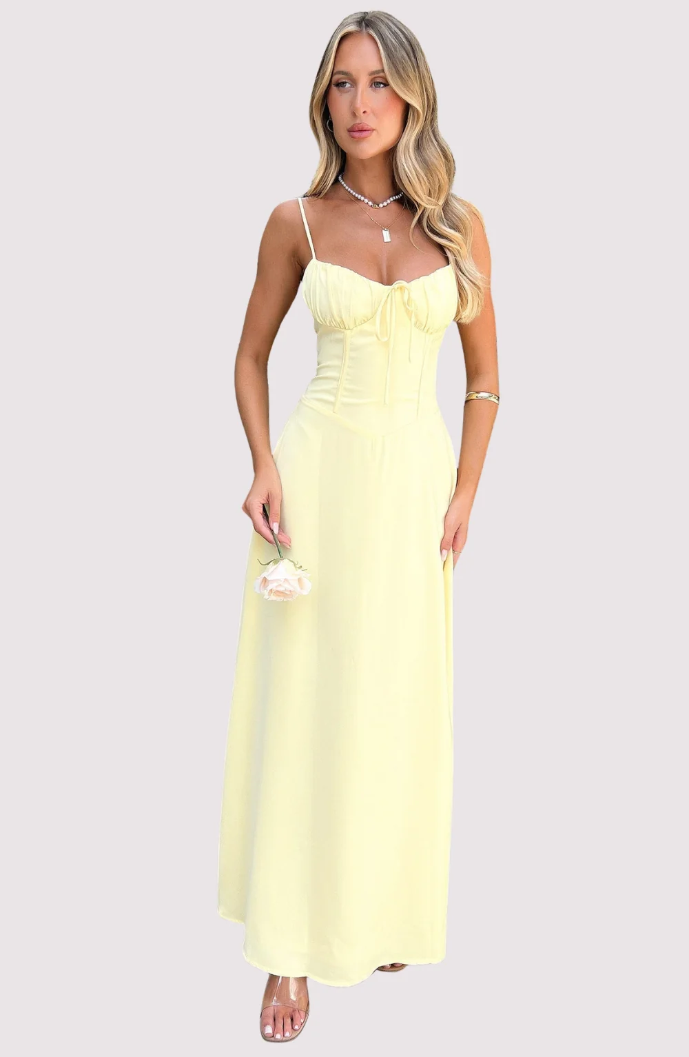 Maxi dress with delicate straps, ruched bust and lace-up back for a custom fit, finished with a flowing A-line skirt. Lightweight, breathable fabric offers graceful movement for weddings, soirées, parties or elegant daytime wear.
