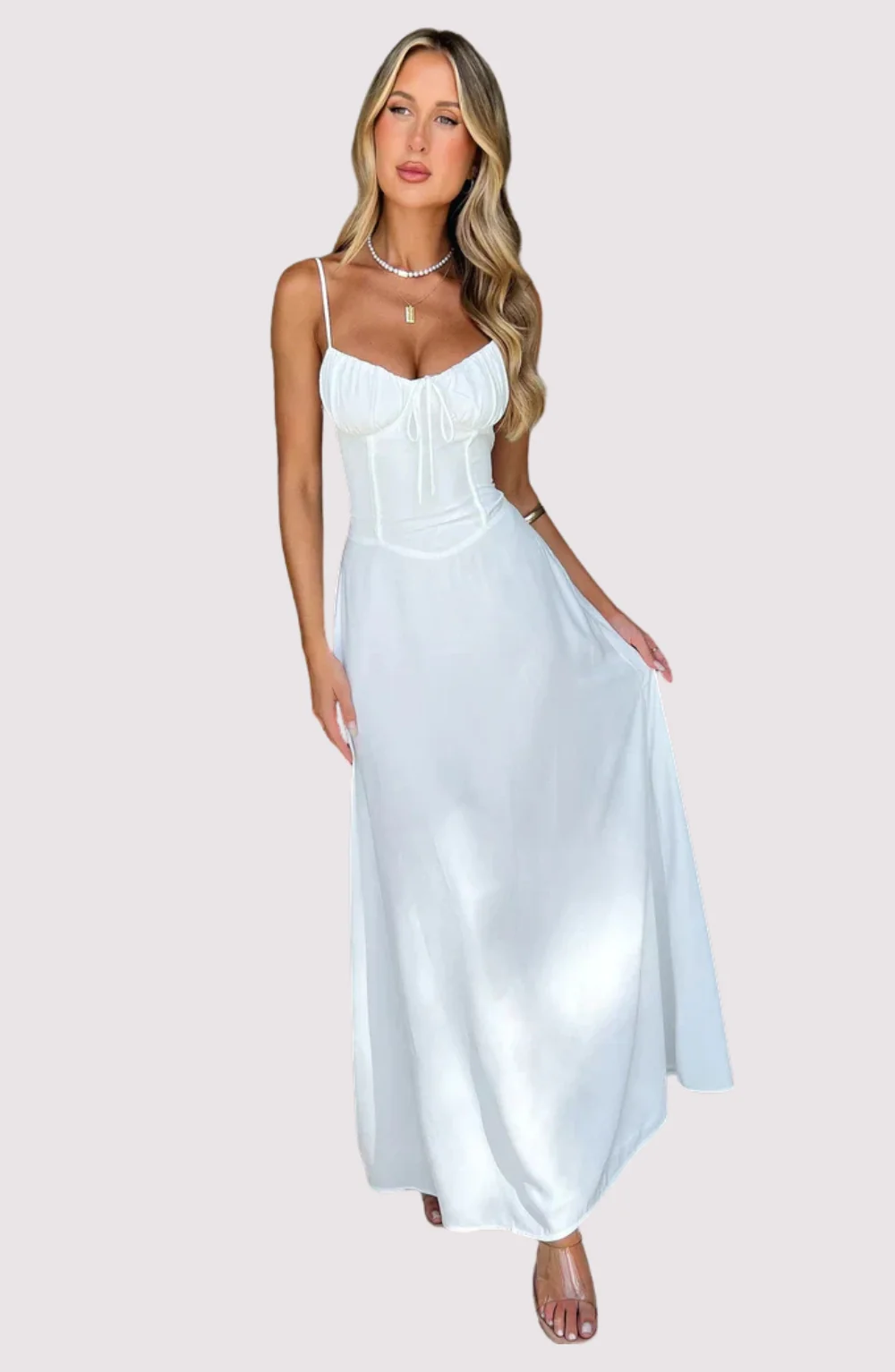 Maxi dress with delicate straps, ruched bust and lace-up back for a custom fit, finished with a flowing A-line skirt. Lightweight, breathable fabric offers graceful movement for weddings, soirées, parties or elegant daytime wear.