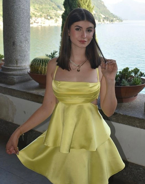 Amalfi Satin Mini Dress in lemon yellow with structured pleated bandeau bodice, adjustable thin straps, open back with criss-cross ties and a flared double-layered skirt. Polyester satin offers fluid movement for parties, vacations and seaside events.
