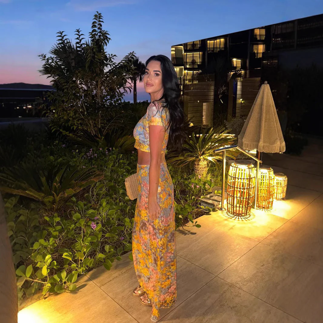 Amaris floral print two piece set featuring a short-sleeve cropped top and matching column maxi skirt in multicolor yellow, pink and grey. Body-skimming silhouette with a lightweight feel, ideal for casual days, brunch and vacations.