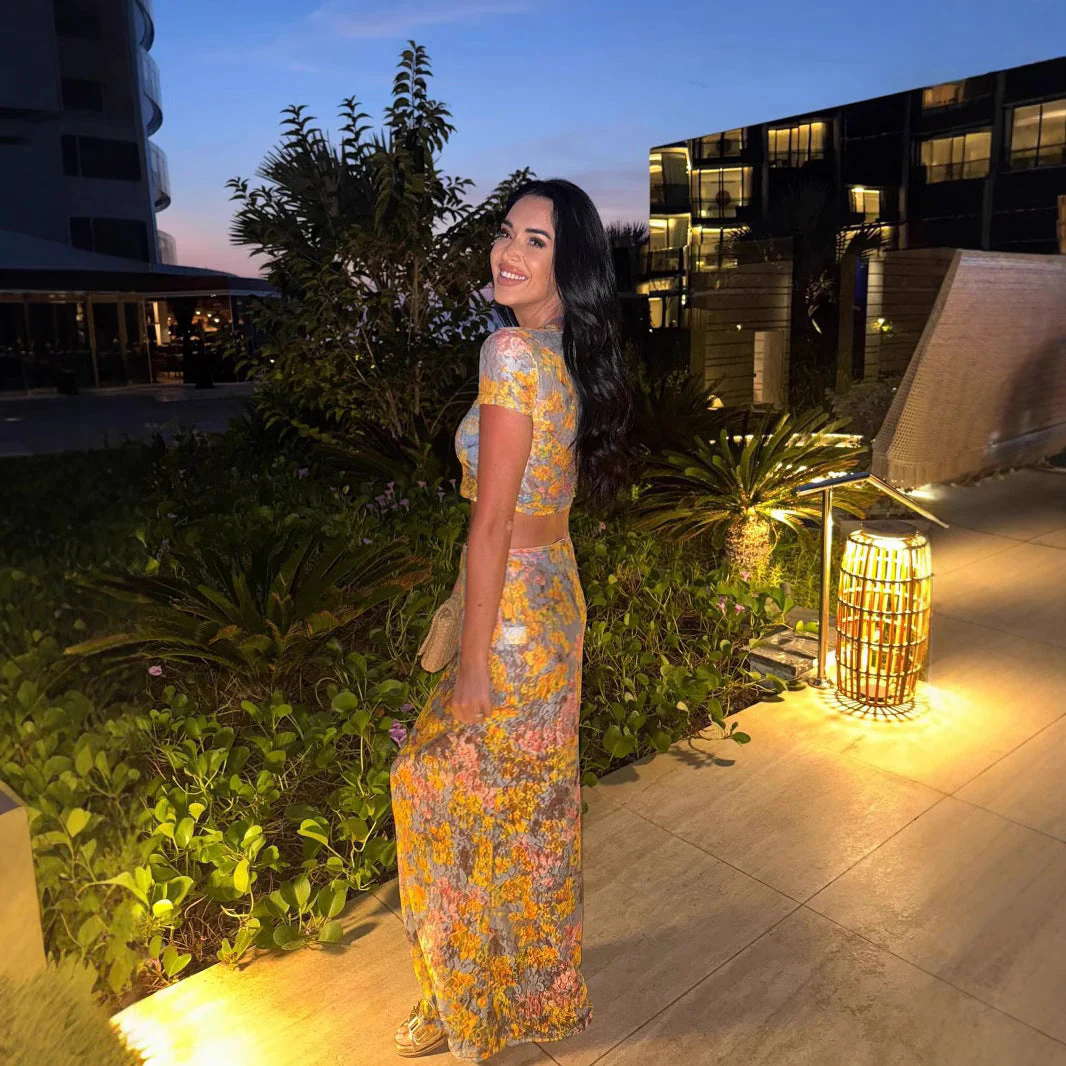 Amaris floral print two piece set featuring a short-sleeve cropped top and matching column maxi skirt in multicolor yellow, pink and grey. Body-skimming silhouette with a lightweight feel, ideal for casual days, brunch and vacations.