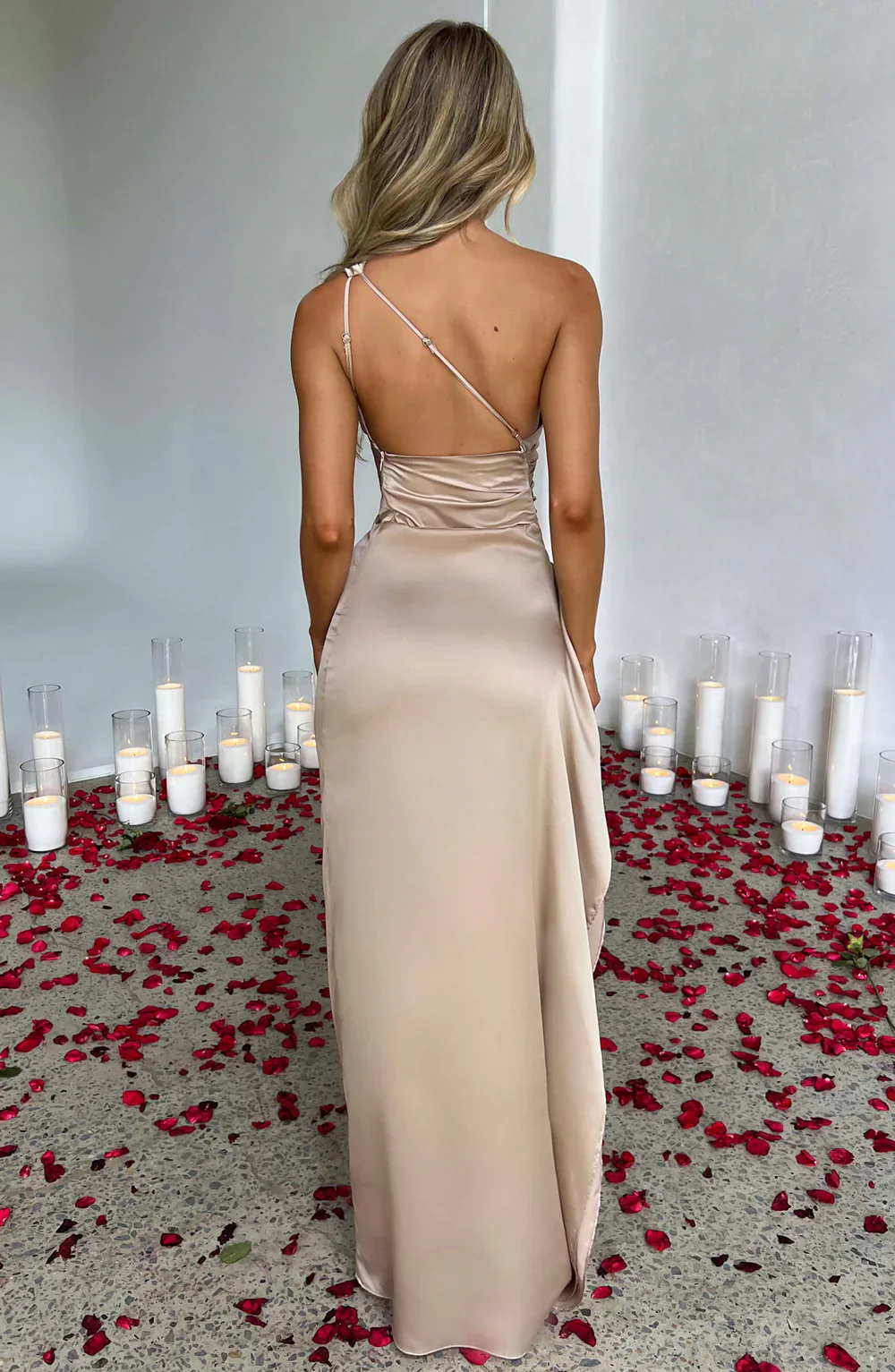Aurora satin slit maxi dress featuring a one-shoulder neckline, backless silhouette, and fluid side slit. Made from a cotton–polyester–elastane satin blend that molds to the body with a smooth, lightweight drape for weddings, galas, and evening occasions.