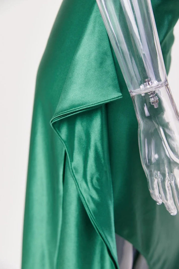 Aurora satin slit maxi dress featuring a one-shoulder neckline, backless silhouette, and fluid side slit. Made from a cotton–polyester–elastane satin blend that molds to the body with a smooth, lightweight drape for weddings, galas, and evening occasions.