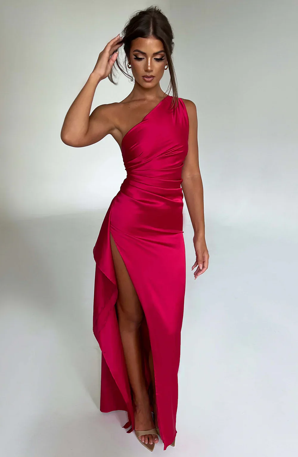 Aurora satin slit maxi dress featuring a one-shoulder neckline, backless silhouette, and fluid side slit. Made from a cotton–polyester–elastane satin blend that molds to the body with a smooth, lightweight drape for weddings, galas, and evening occasions.