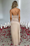 Aurora satin slit maxi dress featuring a one-shoulder neckline, backless silhouette, and fluid side slit. Made from a cotton–polyester–elastane satin blend that molds to the body with a smooth, lightweight drape for weddings, galas, and evening occasions.