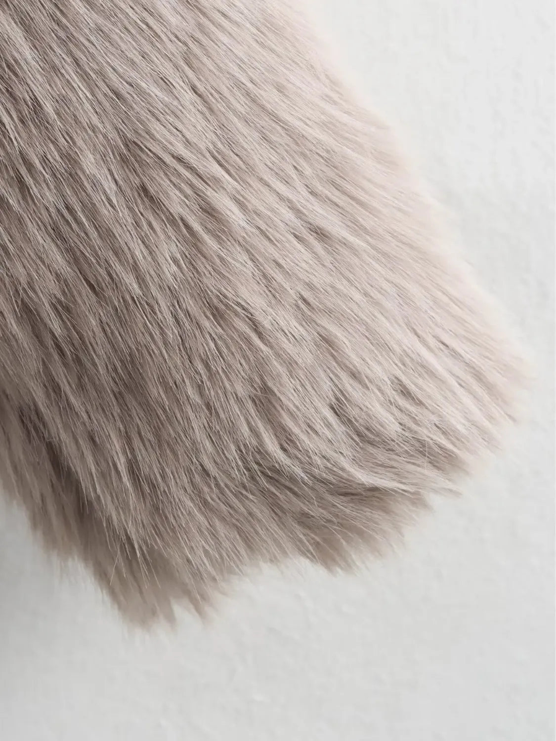 Adele faux fur oversized coat in plush synthetic fibres with wide lapel collar, concealed front and relaxed silhouette. Warm, durable and cruelty-free outerwear that layers over jeans, dresses and evening looks for chic winter style.