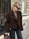 Camille cropped trench jacket in brown wool blend featuring wide lapels, double-breasted buttons, epaulettes and adjustable cuff tabs. Soft, structured fabric and a waist-flattering length for refined layering over knits, dresses or trousers.