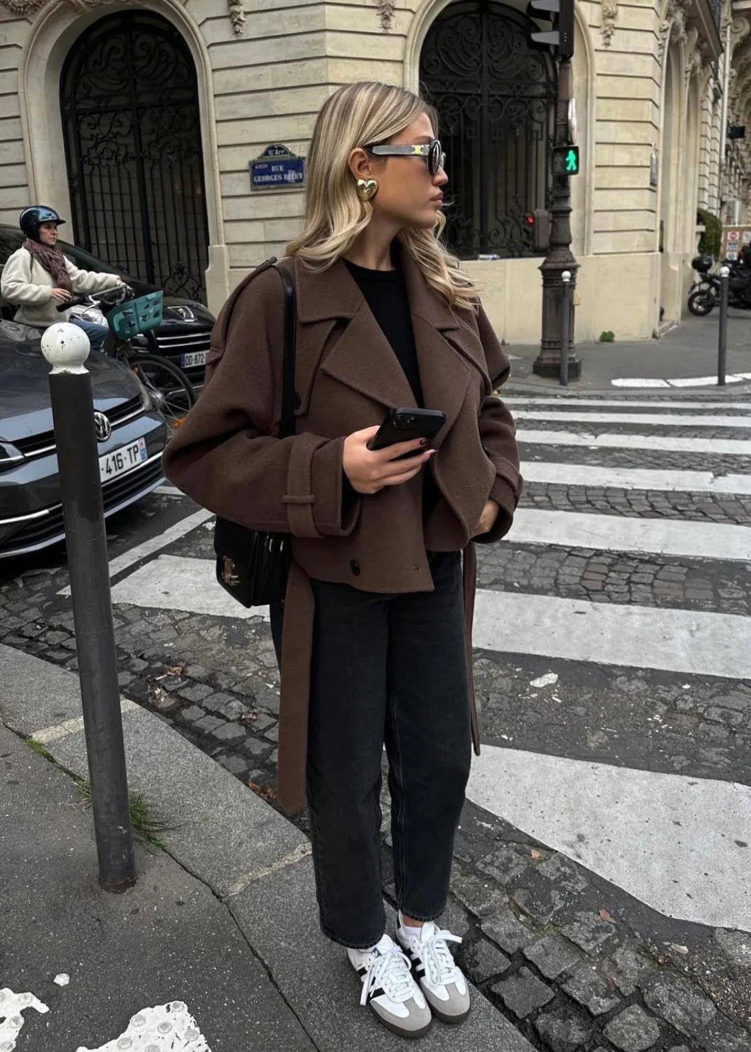 Camille cropped trench jacket in brown wool blend featuring wide lapels, double-breasted buttons, epaulettes and adjustable cuff tabs. Soft, structured fabric and a waist-flattering length for refined layering over knits, dresses or trousers.