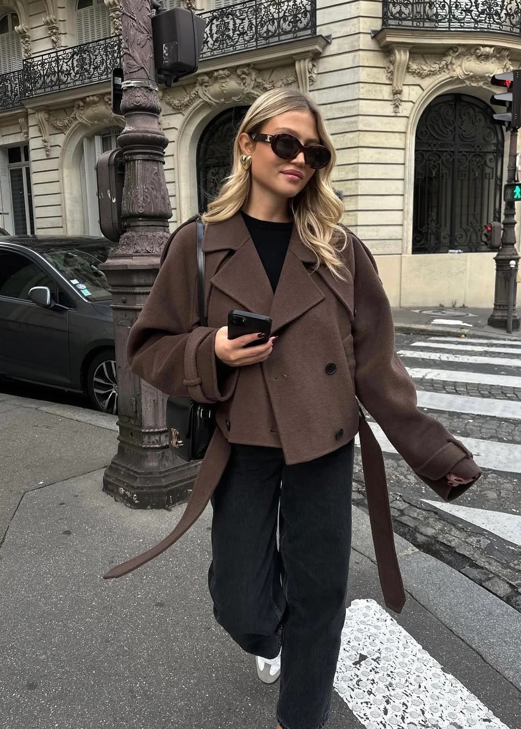 Camille cropped trench jacket in brown wool blend featuring wide lapels, double-breasted buttons, epaulettes and adjustable cuff tabs. Soft, structured fabric and a waist-flattering length for refined layering over knits, dresses or trousers.