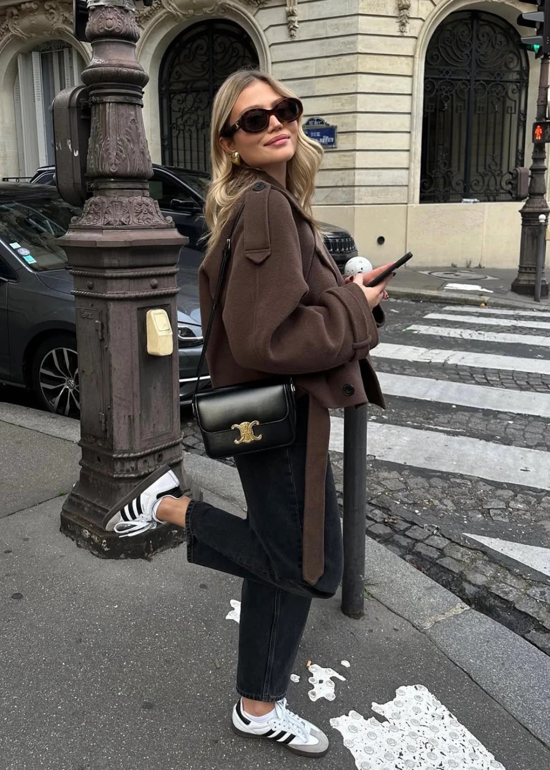 Camille cropped trench jacket in brown wool blend featuring wide lapels, double-breasted buttons, epaulettes and adjustable cuff tabs. Soft, structured fabric and a waist-flattering length for refined layering over knits, dresses or trousers.