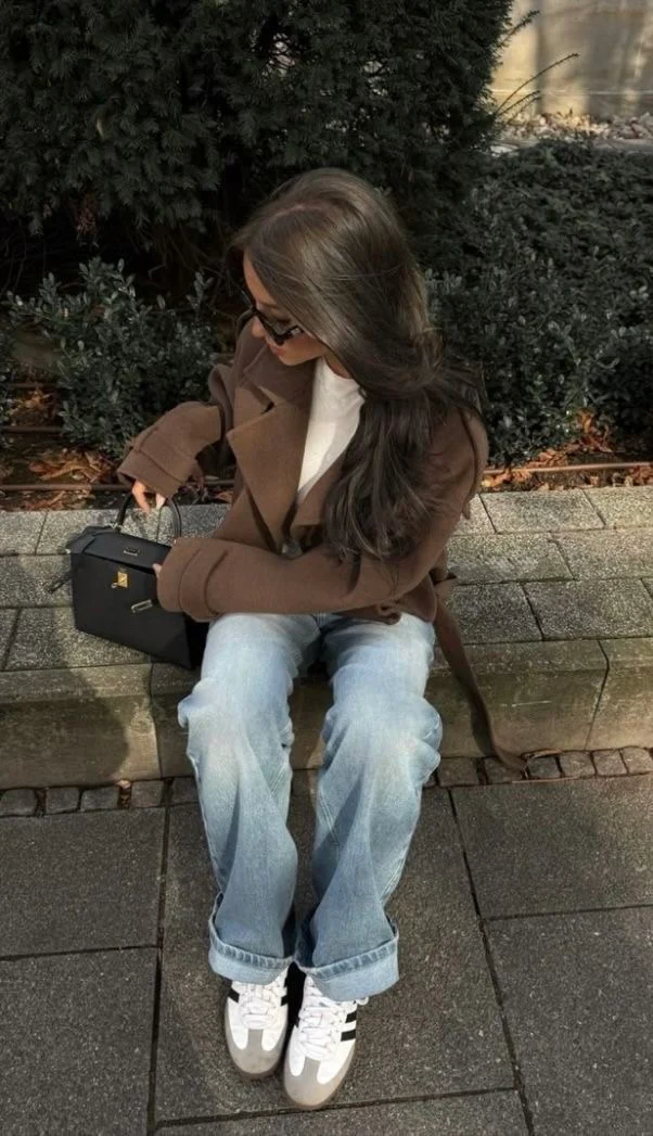 Camille cropped trench jacket in brown wool blend featuring wide lapels, double-breasted buttons, epaulettes and adjustable cuff tabs. Soft, structured fabric and a waist-flattering length for refined layering over knits, dresses or trousers.