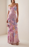 Maxi dress with delicate straps and cascading ruffle tiers, featuring a soft floral pattern and a graceful V neckline; lightweight, fluid drape creates feminine movement, ideal for garden parties, weddings, evening dinners or elegant daytime events.