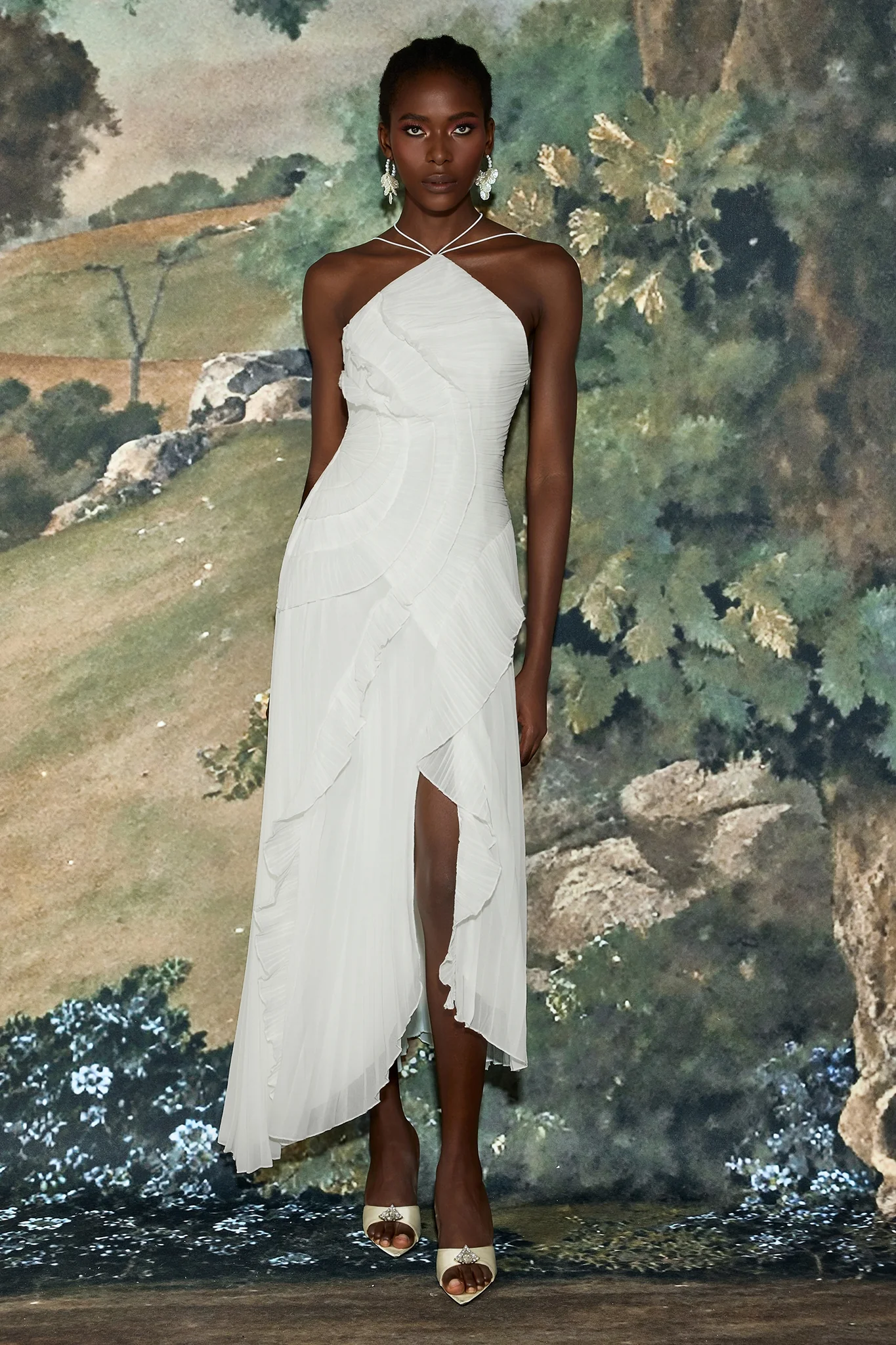 Catherine Ruffle Dress: long asymmetric gown with delicate halter straps, sculpting bodice and cascading pleated ruffles; lightweight chiffon-like polyester with subtle sheen and fluid motion, delivered with a free pearl clutch bag.