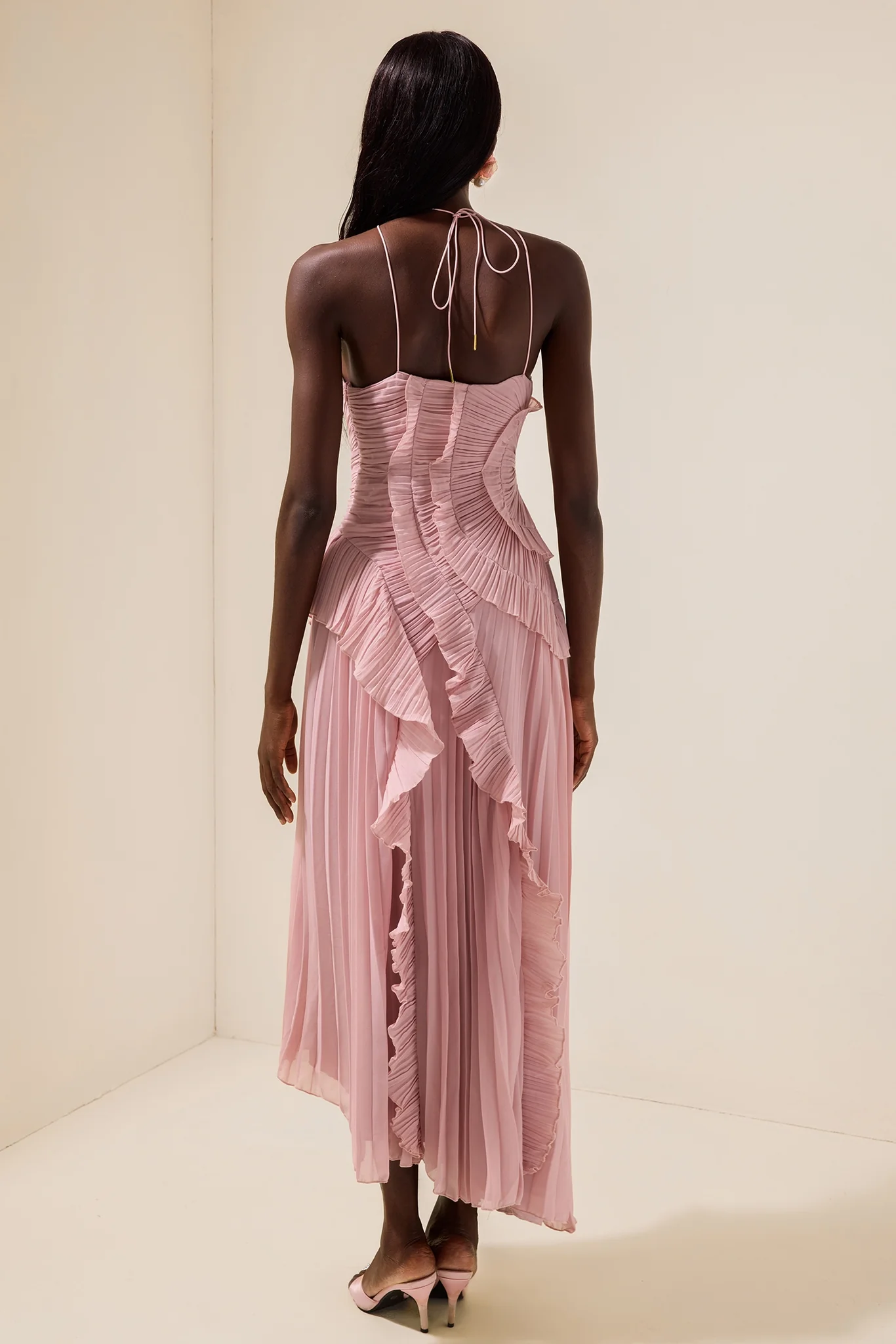 Catherine Ruffle Dress: long asymmetric gown with delicate halter straps, sculpting bodice and cascading pleated ruffles; lightweight chiffon-like polyester with subtle sheen and fluid motion, delivered with a free pearl clutch bag.