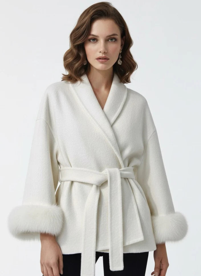 Celine wool-blend belted coat featuring a wrap front, wide lapels and waist-defining tie belt with statement faux fur cuffs. Soft, warm and durable outer layer that elevates autumn-winter outfits from tailored trousers to knit dresses with Parisian elegance.