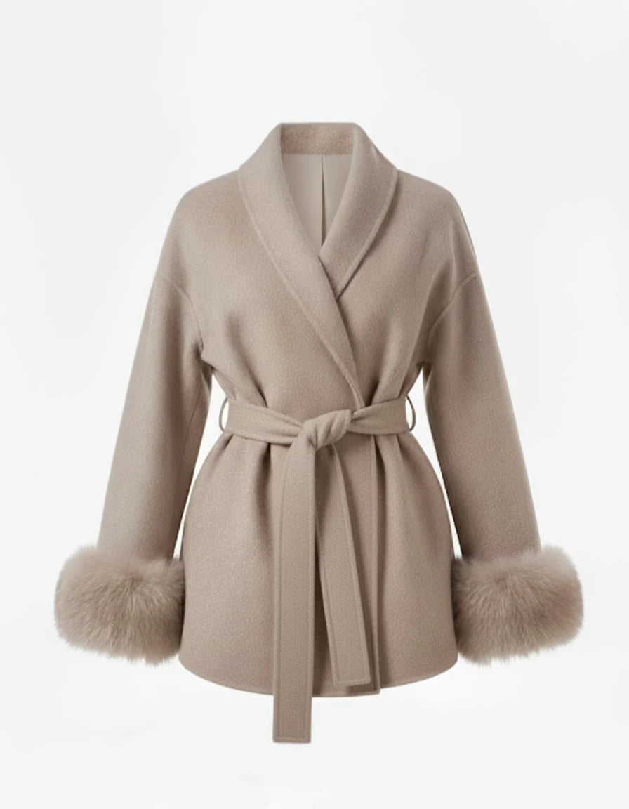 Celine wool-blend belted coat featuring a wrap front, wide lapels and waist-defining tie belt with statement faux fur cuffs. Soft, warm and durable outer layer that elevates autumn-winter outfits from tailored trousers to knit dresses with Parisian elegance.