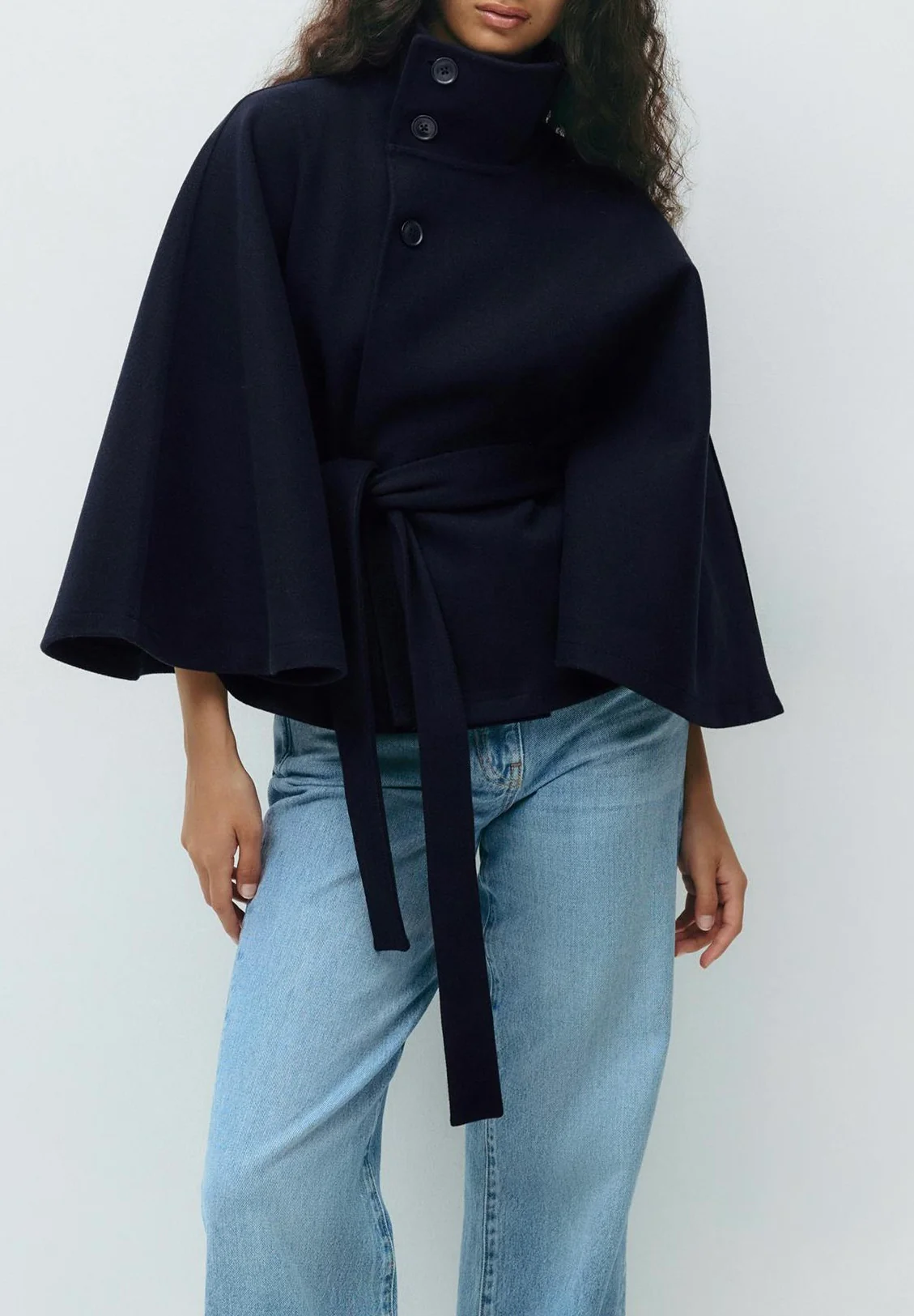 Chloe 2-Pack Cape Bundle featuring two belted capes with high-neck collars, buttoned fronts and detachable waist ties. Soft-touch fabric, flowing drape and versatile colors ideal for layering over dresses, denim or tailored looks.