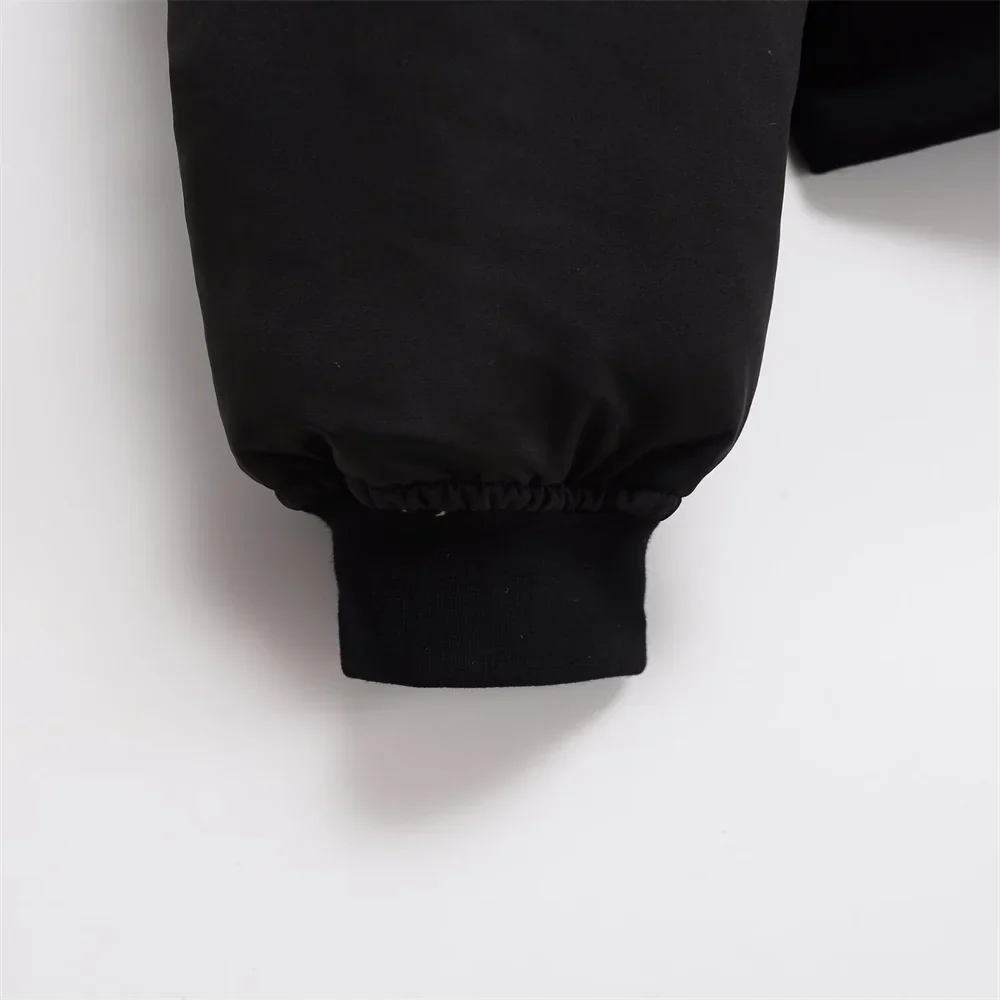 Claire cropped puffer jacket in black, featuring a high padded collar, zip fastening, elasticated cuffs and a smooth polyester shell with lightweight fibre filling. Sleek, warm and non-bulky—ideal over high-waist denim, skirts or tailored trousers.