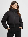 Claire cropped puffer jacket in black, featuring a high padded collar, zip fastening, elasticated cuffs and a smooth polyester shell with lightweight fibre filling. Sleek, warm and non-bulky—ideal over high-waist denim, skirts or tailored trousers.