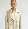 Maya wool-blend double-breasted cropped trench coat in a tailored silhouette with wide lapels and structured shoulders. Warm, durable and comfortable layer for autumn and winter, styled with denim, skirts or trousers.