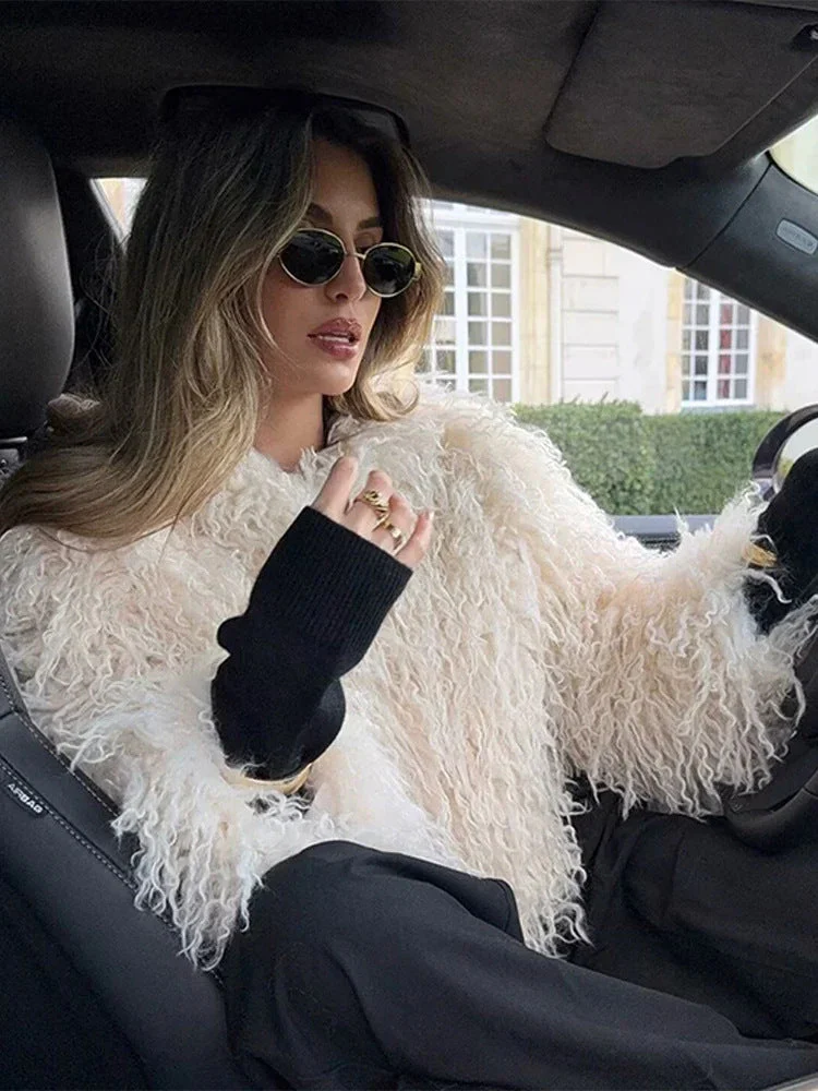 Women’s long-sleeve fur-effect coat in soft off-white featuring a sleek collar, clean front and hip-skimming length. Medium weight provides cosy warmth without bulk, creating an elegant layer over denim, tailoring or evening outfits in cooler months.