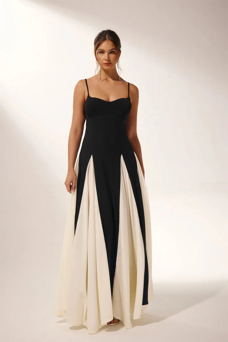 Women’s two-tone contrast maxi dress featuring a contoured black bodice, adjustable slim straps and a fitted waist that releases into an ivory panelled A-line skirt. Smooth, structured polyester shapes the figure; elegant choice for galas and evening events.