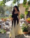 Women’s two-tone contrast maxi dress featuring a contoured black bodice, adjustable slim straps and a fitted waist that releases into an ivory panelled A-line skirt. Smooth, structured polyester shapes the figure; elegant choice for galas and evening events.