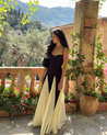 Women’s two-tone contrast maxi dress featuring a contoured black bodice, adjustable slim straps and a fitted waist that releases into an ivory panelled A-line skirt. Smooth, structured polyester shapes the figure; elegant choice for galas and evening events.