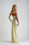 Emory satin backless maxi dress featuring an off-shoulder band, soft twist at the bust, and a sleek, body-skimming silhouette that falls to the floor. Lightweight satin with a refined sheen—ideal for weddings, formal dinners, and elegant evening events.