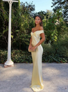 Emory satin backless maxi dress featuring an off-shoulder band, soft twist at the bust, and a sleek, body-skimming silhouette that falls to the floor. Lightweight satin with a refined sheen—ideal for weddings, formal dinners, and elegant evening events.