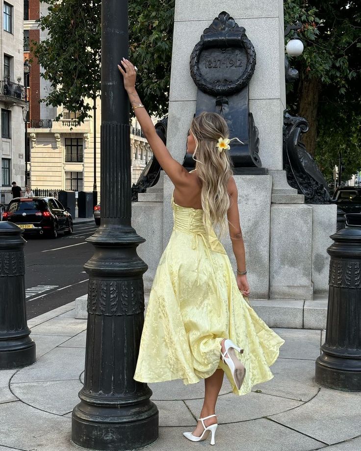 Esmeralda halter sleeveless midi dress featuring a deep V neckline, corset-inspired waist and full A-line skirt. Floral textured fabric adds shine and dimension; mid-calf length keeps movement graceful—perfect for weddings, parties and chic daylight events.