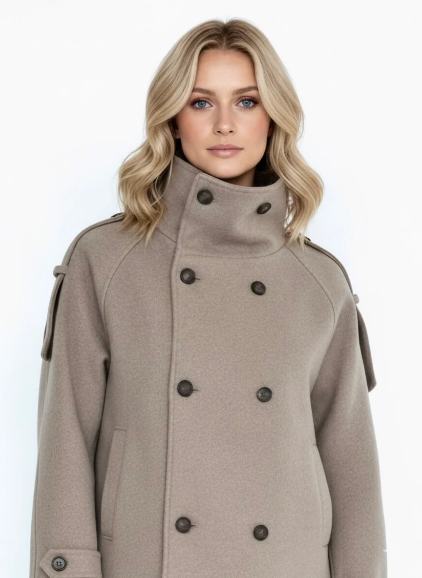 Evie high-neck wool-blend jacket featuring a structured tall collar, double-breasted button closure, adjustable cuffs and a slightly cropped silhouette. Soft, insulating fabric and clean lines for versatile layering with jeans, skirts or tailored trousers.