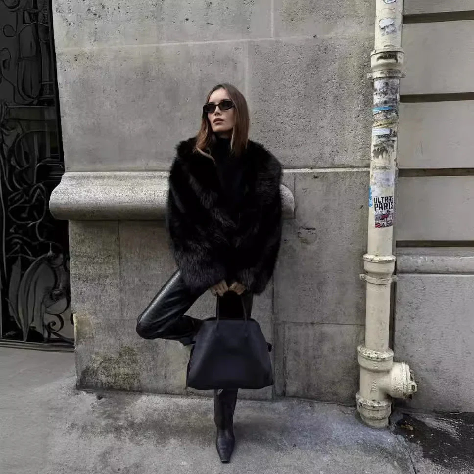 Women’s faux-fur coat in a plush, black finish featuring a wide lapel and a relaxed, waist-skimming silhouette. Soft, cosy texture adds refined warmth and layers effortlessly over dresses, denim or tailored looks for day-to-night elegance.