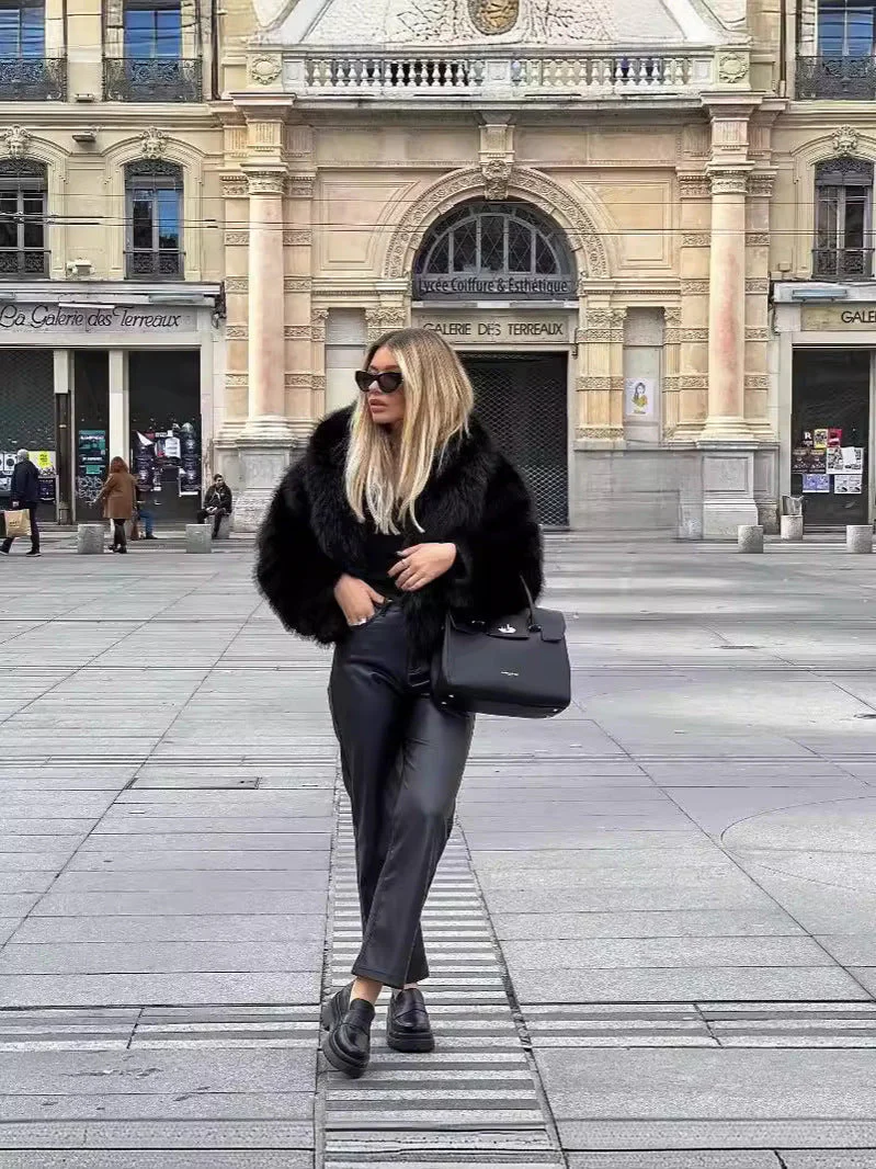 Women’s faux-fur coat in a plush, black finish featuring a wide lapel and a relaxed, waist-skimming silhouette. Soft, cosy texture adds refined warmth and layers effortlessly over dresses, denim or tailored looks for day-to-night elegance.