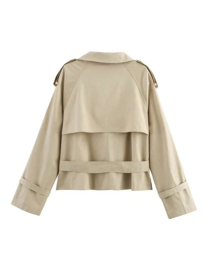 Isabelle high-neck belted trench coat in premium cotton blend with structured stand collar, double-breasted buttons, epaulettes and adjustable cuffs. Tailored silhouette layers over dresses, denim or trousers for refined autumn-winter style.