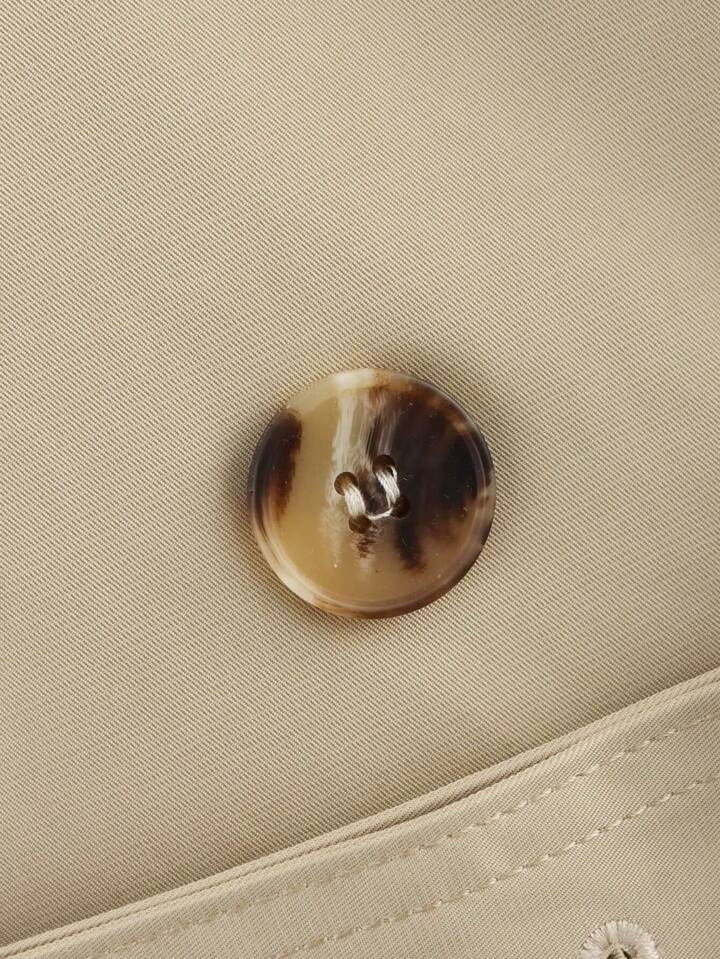 Isabelle high-neck belted trench coat in premium cotton blend with structured stand collar, double-breasted buttons, epaulettes and adjustable cuffs. Tailored silhouette layers over dresses, denim or trousers for refined autumn-winter style.