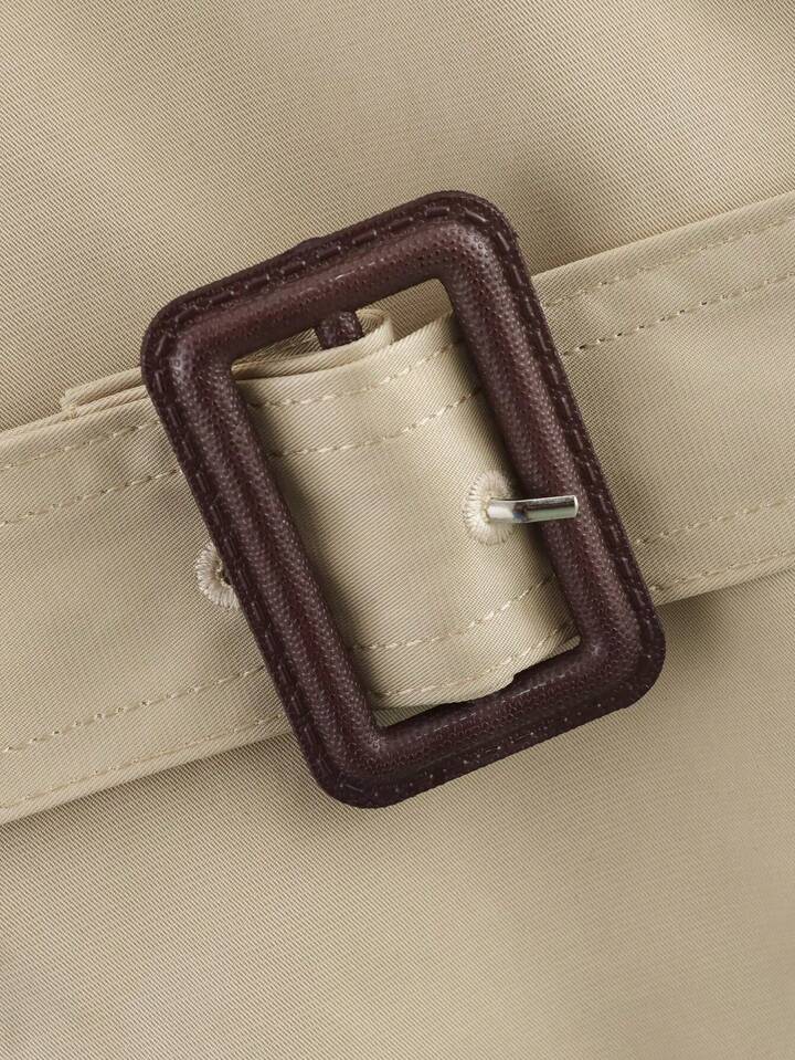 Isabelle high-neck belted trench coat in premium cotton blend with structured stand collar, double-breasted buttons, epaulettes and adjustable cuffs. Tailored silhouette layers over dresses, denim or trousers for refined autumn-winter style.