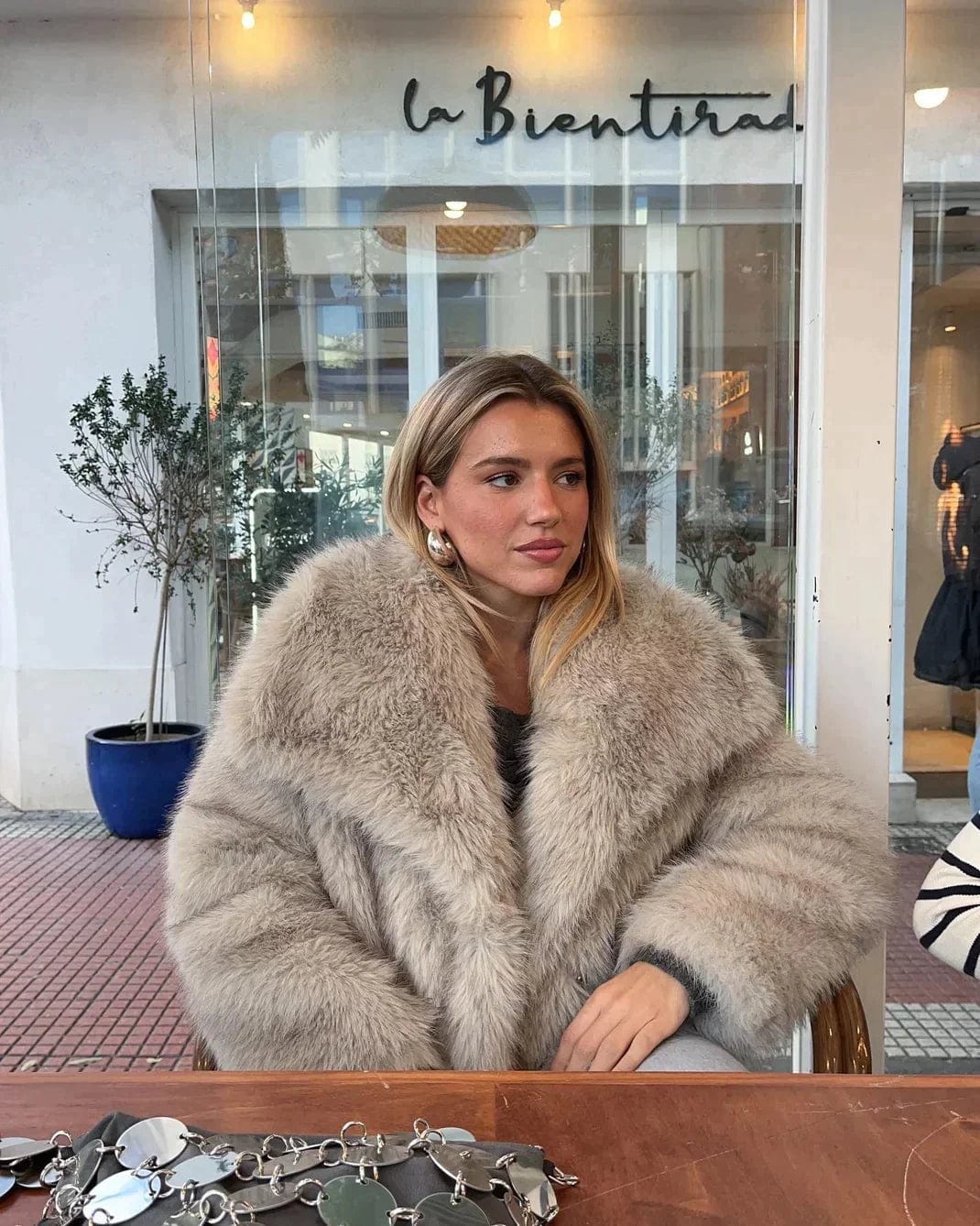 Women’s faux-fur coat in off-white with a softly structured collar and feminine, slim silhouette. High-quality build provides warm yet breathable comfort for Autumn/Winter. Versatile design pairs with denim, tailoring or evening dresses; also in Beige or White.