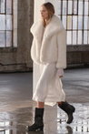 Women’s faux-fur coat in off-white with a softly structured collar and feminine, slim silhouette. High-quality build provides warm yet breathable comfort for Autumn/Winter. Versatile design pairs with denim, tailoring or evening dresses; also in Beige or White.