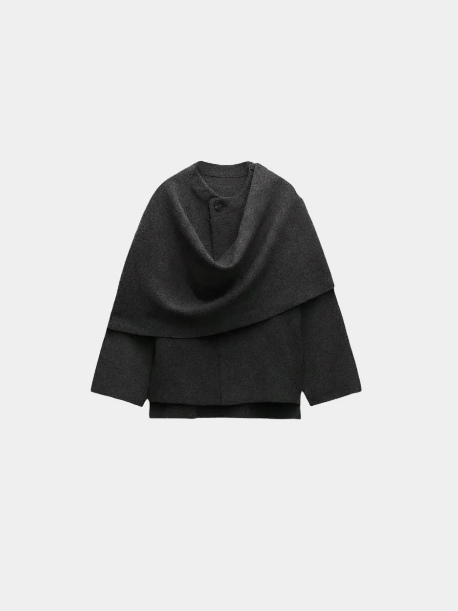 Women’s oversized warm coat featuring a draped, fold-over neckline, relaxed cocoon silhouette and asymmetric hem. Soft-touch construction adds cosy warmth without bulk, layering smoothly over knitwear, dresses or tailoring for refined everyday style.